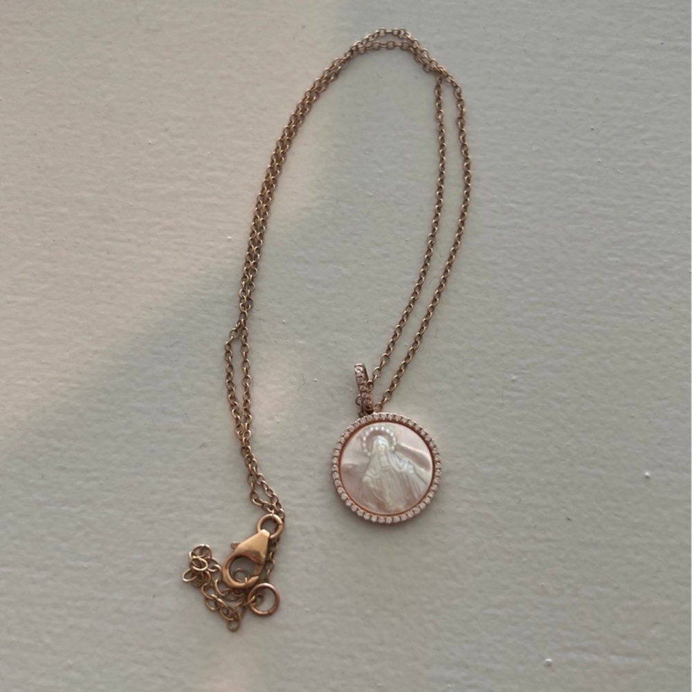 Gold Mary pendant, a little bit of discoloration.